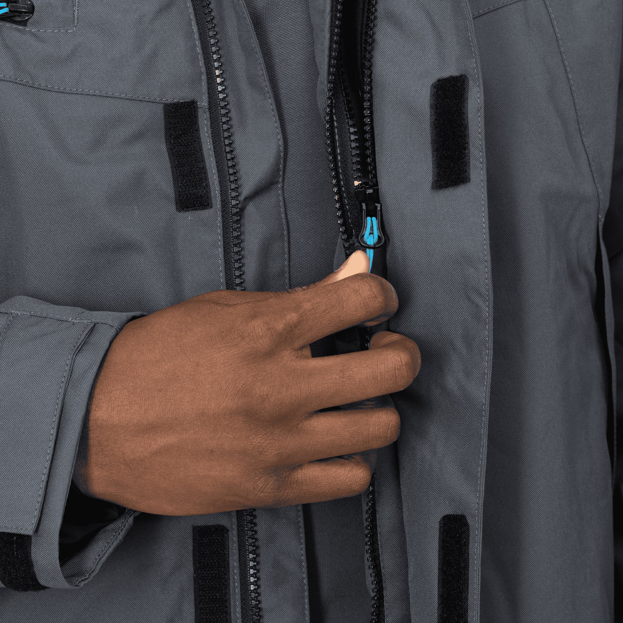 grey winter jacket with black zipper and blue details