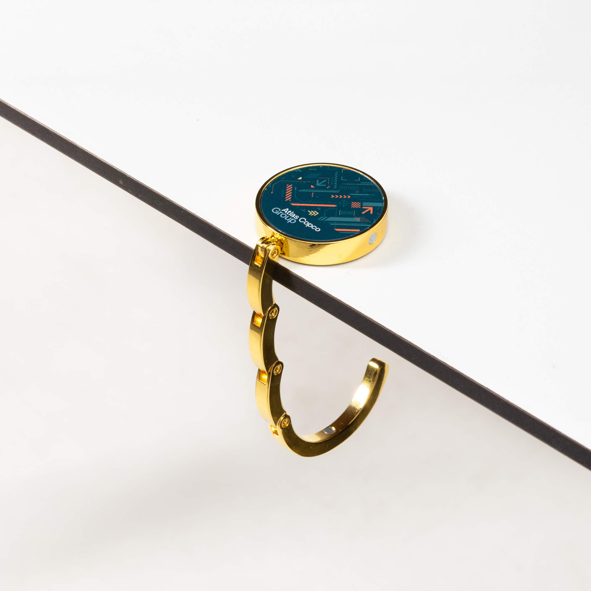 bag hanger with atlas copco group logo on table