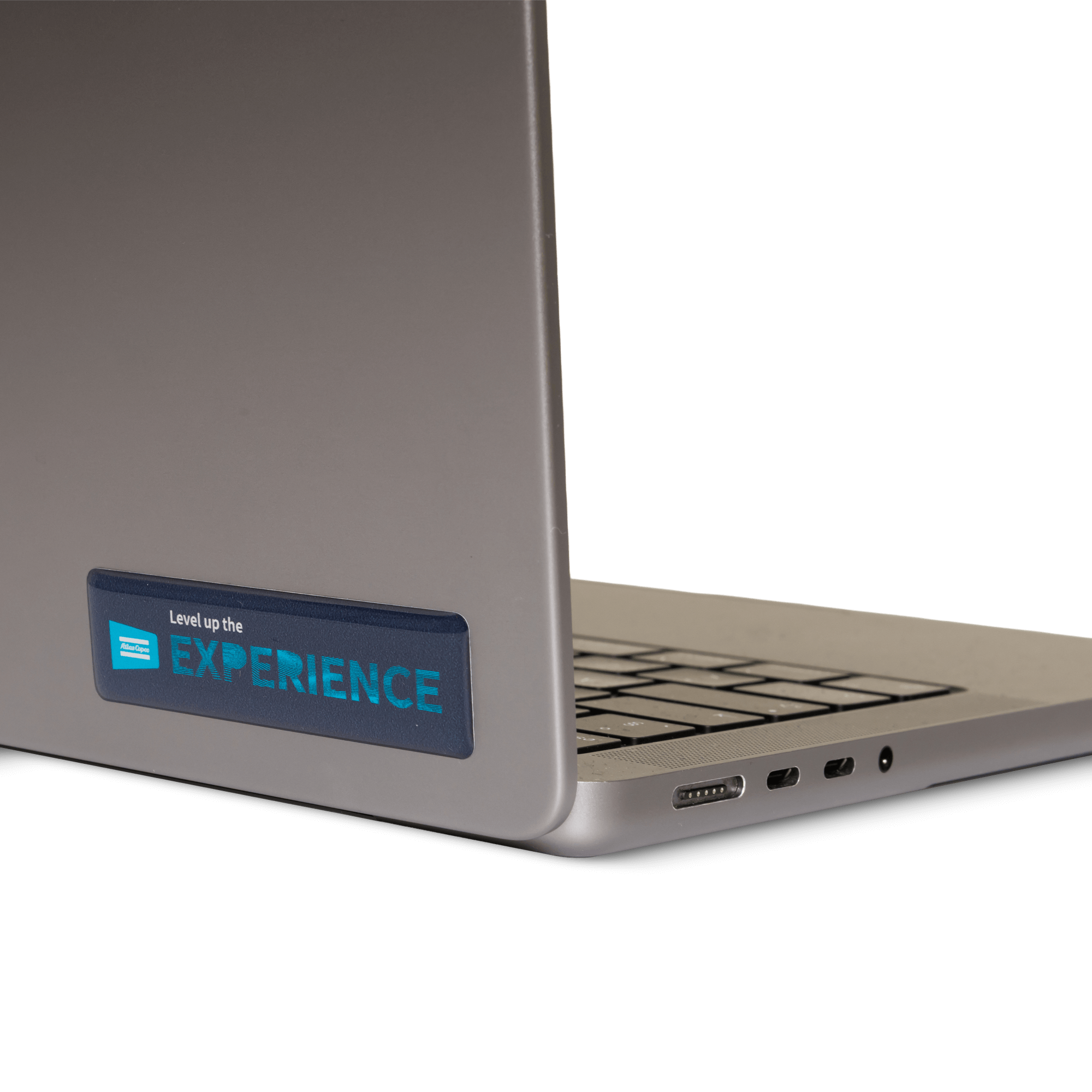 Atlas copco stickers with level up the experience text and graphics on laptop