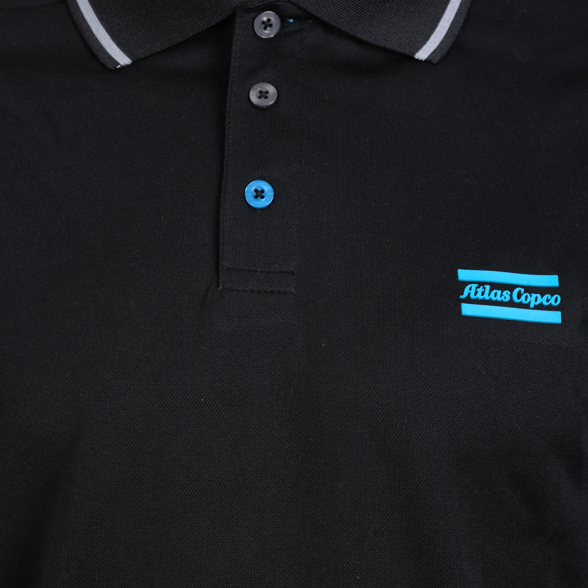black polo with blue atlas copco logo closeup